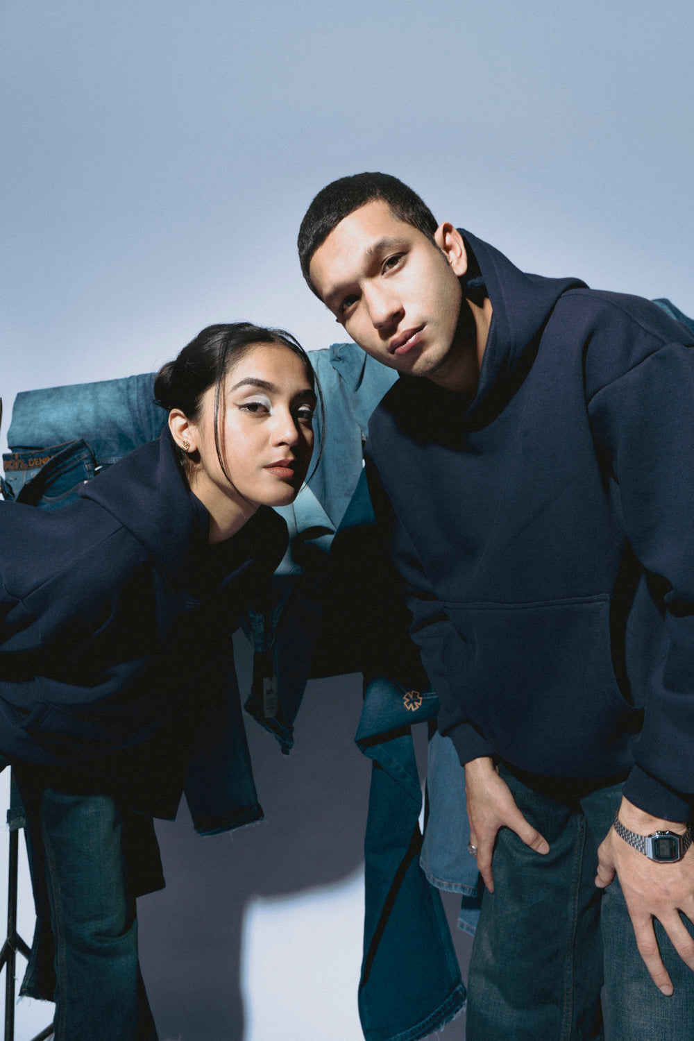 Couple wearing SOH Hoodies against a light background