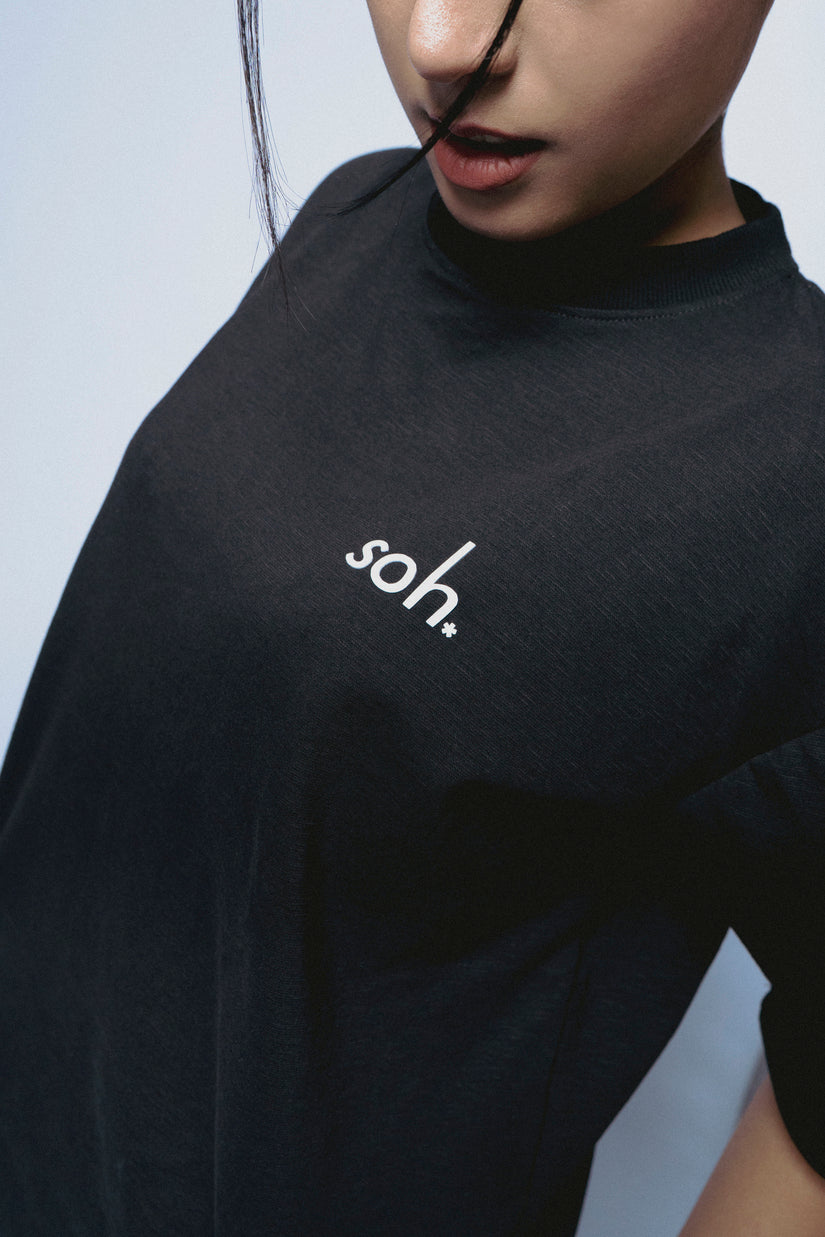 Person wearing a black SOH Mark T-shirt 