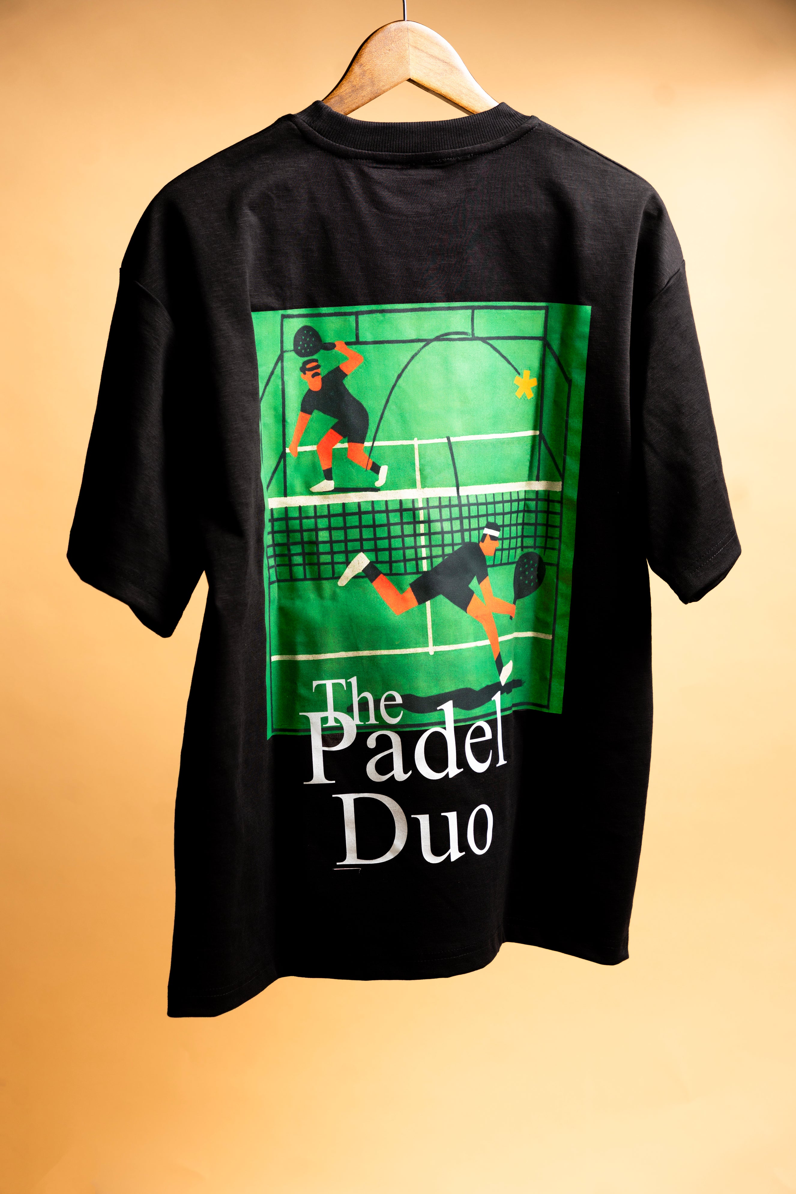 Black SOH Padel Tshirt t-shirt with 'The Padel Duo' graphic on a beige background