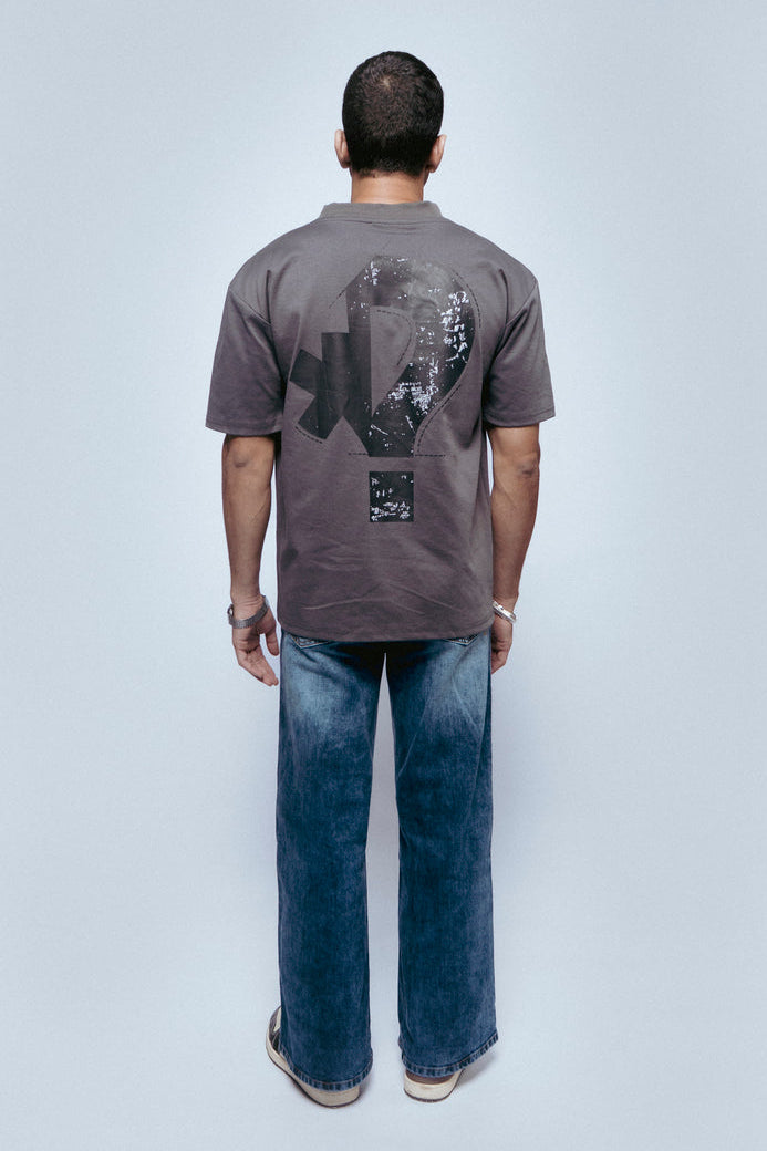 Person wearing a gray SOH Question T-shirt with a graphic design on a white background